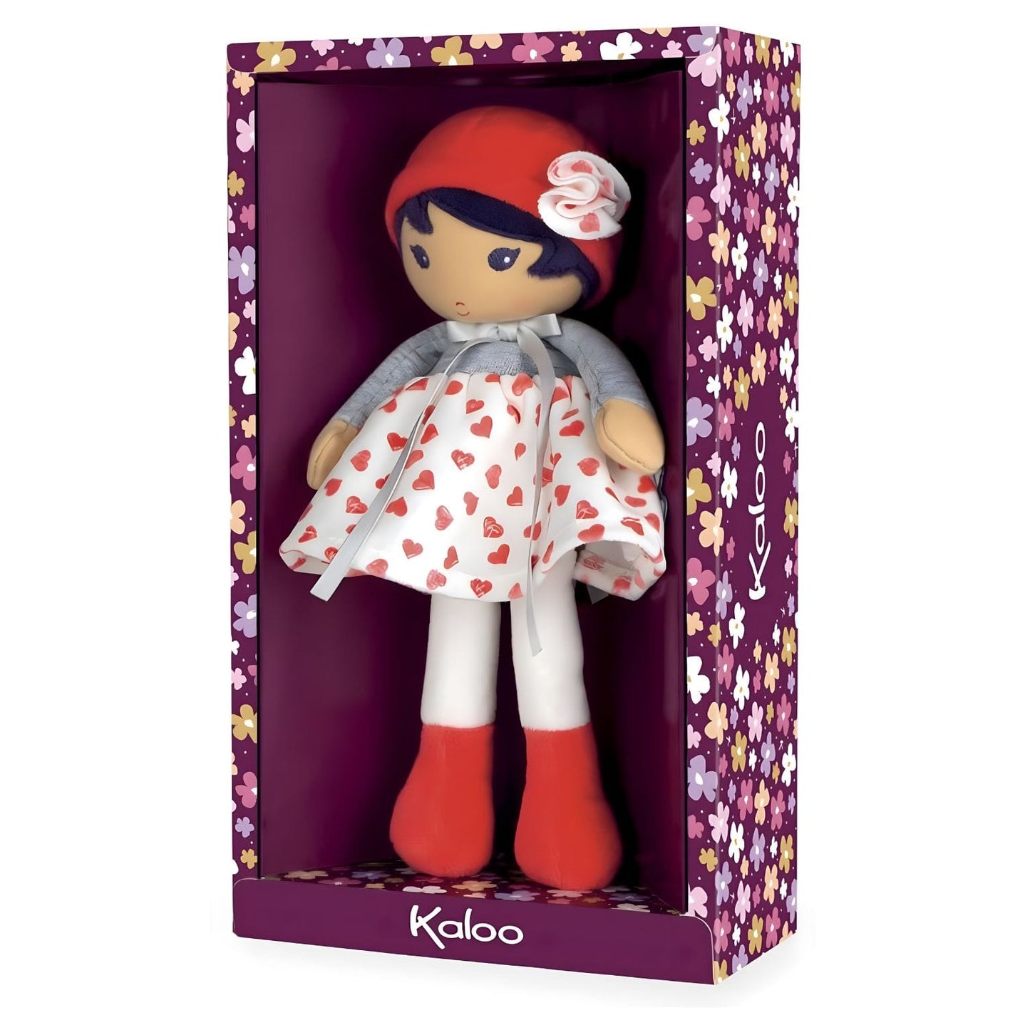 Boneca de Pano Jade da Kaloo com vestido branco de corações vermelhos, camisola cinzenta e gorro vermelho