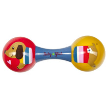 Bebé a brincar com Maracas do cão Dachshund coloridas da Spiegelburg